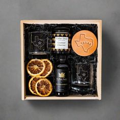 a wooden box filled with oranges and other items