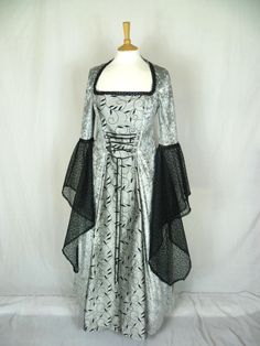 This listing is for a custom made dress,it will be made to the measurements you send me. Please send me a message with your bust ,waist and hip measurements,and please measure from the top of your shoulder to the floor with shoes on. It will be made with beautiful silver grey crushed velvet and stunning grey and black silk fabric. The sleeves are part velvet with a stunning black embroidered organza .It has a corset style front and back with lacing so you can adjust the dress to fit your body sh Black A-line Wedding Gown, Black Floor-length Corset Dress With Boned Bodice, Black Dresses With Corset Back And Fitted Bodice, Black Dress With Corset Back And Fitted Bodice, Fitted Gothic Gown For Fancy Dress, Gothic Fitted Gown For Fancy Dress, Elegant Black Gown For Costume, Elegant Black Costume Gown, Elegant Black Gown For Fancy Dress