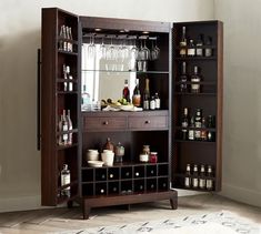 a cabinet with wine glasses and liquor bottles in it