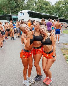 three women in swimsuits are posing for the camera with their arms around each other