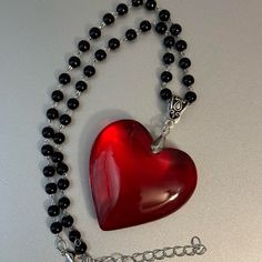 Black Beaded Necklace With Big Large Red Glass Crystal Heart Pendant Charm Brand New Big Red Crystal Glass Heart Charm Pendant Choker Necklace 3d Heart Pendant Chunky Heart Necklace Super Adorable Necklace, You Will Love The Contrast Between The Red Heart And The Black Of The Beads. *Glass Heart Pendant Size: 43mm *Necklace Length: 34cm+5cm Extension Chain. *Brand New. *Will Ship Next Day Or Same Day If Possible. *Make A Bundle Of 2 Or More Items And Save $2 (Message Me First!) #Bigredcrystalhea Chunky Heart Necklace, Jewelry Cottagecore, Fairycore Jewelry, Black Beaded Necklace, Vintage Rhinestone Necklace, Pendant Choker Necklace, Crystal Heart Necklace, Flower Statement Necklace, Black Velvet Choker