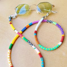 This handmade unique glasses accessory is carefully hand-woven using the highest quality glass seed beads! It is an abstract one-of-a-kind boho style glasses chain with vibrant colors! Lenght 27 inc (70 cm ) It is not only a glasses lanyard, but also a sunglasses chain that you can use as a long necklace, wrap bracelet, or mask chain! You are guaranteed to receive all the compliments thanks to the colorful glasses necklace that is compatible with all your clothes that you can use in all seasons! Colorful Glasses, Glasses Necklace, Glasses Lanyard, Beaded Sunglasses, Unique Glasses, Eyeglass Necklace, Glasses Chains, Sunglasses Chain, Lanyard Necklace