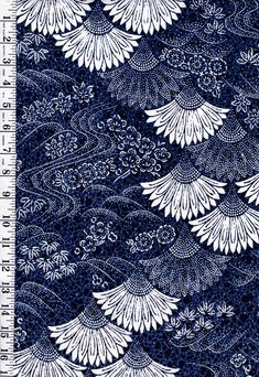 a ruler with white flowers on it and blue fabric in the background, as well as a