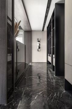 an empty hallway with black and white walls