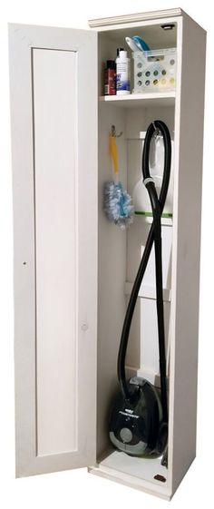 a white cabinet with a black vacuum and cleaning supplies in the bottom section, on a white background