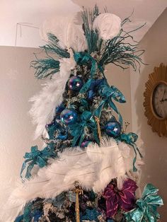 a christmas tree decorated with feathers and ornaments