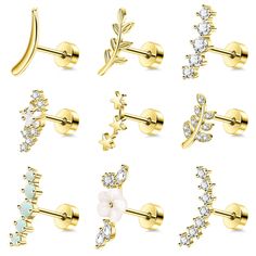 six pairs of gold earrings with white stones and leaves on each ear, all in different shapes