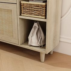 a white purse sitting on top of a wooden shelf next to a basket filled with books