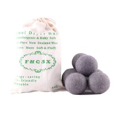 three balls of wool sitting next to a bag