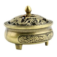 a brass incense bowl with dragon design on the lid