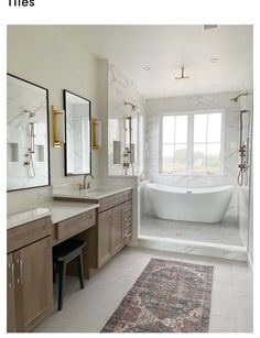 a bathroom with two sinks and a bathtub next to a large mirror on the wall