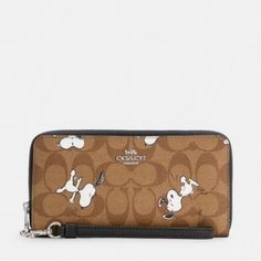 Coach X Peanuts Long Zip Around Wallet In Signature Canvas With Snoopy Print Signature Coated Canvas And Smooth Leather Twelve Credit Card Slots Full-Length Bill Compartments Inside Zip Coin Pocket Zip-Around Closure Detachable Wrist Strap 7 1/2" (L) X 4" (H) X 1" (W) Coach X Peanuts Casual Coach Wallets For Daily Use, Casual Coach Wallet For Daily Use, Casual Coach Wallets For Everyday Use, Casual Coach Everyday Wallets, Casual Everyday Coach Wallets, Snoopy Print, Peanut Snoopy, Leather Wallets, Signature Canvas