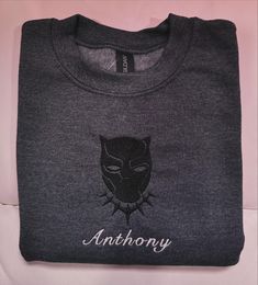 Our personalized Black Panther Embroidered Kids Crewneck. Each item is personalized just for you. To make your purchase: Pick your preferred sweatshirt/hoodie color. Pick the right size for a comfy fit. Select the thread color you like for the embroidery. This color will be used for all embroidery. Tell us exactly what design you want embroidered. Just so you know, our sweatshirts are made with top-notch quality from a Gildan blend of 50/50 cotton and polyester. Size Information: Our sweatshirts are made to be unisex regular fit, so stick to your usual size for a comfy fit. If you're in between sizes or prefer a snug fit, go a size down. To be precise, measure a similar shirt at home while it's flat. Care Instructions: Although our sweatshirts are durable for multiple washes, we suggest wa Black Panther Embroidery, Black Cotton Sweater With Embroidered Logo, Black Crew Sweatshirt With Embroidered Graphics, Black Sweater With Letter Embroidery For Winter, Black Sweater With Embroidered Graphics For Streetwear, Black Cotton Sweatshirt With Embroidered Logo, Black Embroidered Cotton Sweater, Black Cotton Embroidered Sweater, Custom Embroidery Crew Neck Sweater For Streetwear