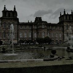 a large building with a fountain in front of it