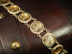 "This exquisite vintage bracelet comes with an appraisal card from North American Gem Lab of Bellevue Washington appraising for $2,700.00. It features 10 Saint-Gaudens double eagle replica coins dated 1914. This bracelet is in excellent condition! The bracelet is hallmarked 14k and measures 13mm wide by 7\" long. Items $100 or more are shipped in a velvet gift box. Items less then $100 will be shipped in a cardboard box with tissue and a fabric ribbon, ready for gift giving or just for safekeepi Antique 14k Stamped Gold Bracelet, Antique Gold Bracelet Stamped 14k, Antique Yellow Gold Bracelet For Formal Occasions, Antique Yellow Gold Bracelets For Formal Occasions, Victorian Yellow Gold Bracelet For Formal Occasions, Antique 14k Gold Formal Bracelets, Antique 14k Gold Bracelets For Formal Occasions, Victorian Gold Bracelet For Formal Occasions, Heirloom Yellow Gold Bracelet For Ceremonial Events