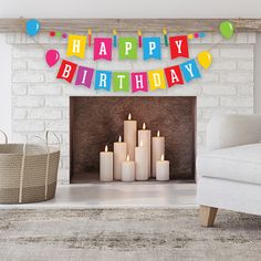 a birthday banner with candles in front of a fireplace