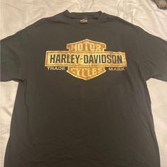 a harley davidson t - shirt is laying on a bed with the words, trade mark