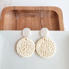 These lightweight rattan earrings are a great addition to your jewelry box. With their neutral resort wear style, these earrings can match anything! They feature a modern, clean design that can be worn every day or with a dressy outfit, and they're light enough to forget you're wearing them as you move around your day. They can go from beachside cocktail to dinner date in a snap, making it the perfect accessory for travel. Hypoallergenic stainless steel posts Durable plant-based acrylic posts Ha White Woven Earrings For Gift, White Woven Beach Jewelry, Bohemian White Earrings For Beach, Trendy Vacation Earrings, Woven Natural Jewelry For Vacation, Natural Woven Jewelry For Vacation, Trendy Adjustable Beige Earrings, Chic Round Earrings For Summer, Elegant Woven Jewelry For Vacation