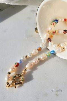 This beautiful Pearl & Millefiori Necklace is the most trendy, affordable and high-quality handmade piece you ever have, is made of Freshwater Pearls, and glass millefiori beads, each necklace is beaded in a unique pattern, which means each necklace is different from others, this delicate design makes it perfect for an effortless look 💕 Multicolor Pearl Charm Jewelry As Gift, Multicolor Pearl Charm Jewelry Gift, Multicolor Jewelry With Pearl Charm For Gift, Multicolor Jewelry With Pearl Charm As Gift, Multicolor Pearl Charm Necklace For Gifts, Multicolor Necklaces With Pearl Charm As Gift, Flower Shaped Single Strand Beaded Necklace For Gift, Colorful Beads Pearl Necklace Gift, Colorful Beaded Round Pearl Necklace Gift