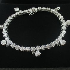 Sterling Silver Diamonique Simulated Diamond Dangling Heart Tennis Bracelet *Measures 7" Long X Approx. 1/4" Wide *Seven Dangling Hearts *Stamped .925 *Pre-Owned In Perfect Condition Heart Tennis Bracelet, Qvc Jewelry, Heart Stamp, Jewelry Sterling Silver, Tennis Bracelet, Womens Jewelry Bracelets, Tennis, Size 7, Women Jewelry