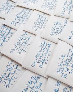 many envelopes with blue writing on them