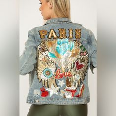 a woman wearing a jean jacket with patches on it