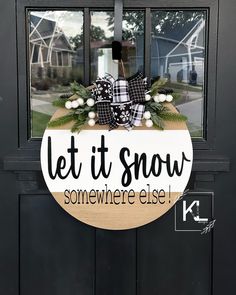 a sign that says let it snow somewhere else on the front door to a house