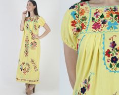 Vintage traditional Mexican Puebla maxi dress. Tailored chest with puffed cap sleeves.  Gathered and draped trapeze shift fit. Yellow soft cotton with bright floral hand embroidery. size estimate: S/M shoulders: 16" bust: 36" waist: 47" hips: 48" total length: 52.5" * Visit the shop * https://www.etsy.com/shop/americanarchive Model is 5'9" and measures 32" bust, 25" waist, 35.5" hips. Belts/accessories are not included unless noted in the description. Spring Fiesta Embroidered Maxi Dress, Yellow Folk Dress For Spring, Multicolor Spring Maxi Dress For Fiesta, Multicolor Maxi Dress For Spring Fiesta, Spring Fiesta Multicolor Maxi Dress, Spring Embroidered Yellow Maxi Dress, Traditional Short Sleeve Maxi Dress For Spring, Spring Yellow Embroidered Maxi Dress, Short Sleeve Multicolor Embroidered Maxi Dress