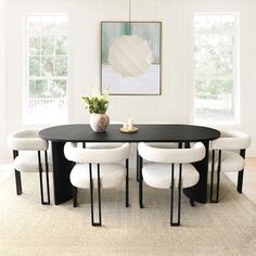 a black table with four white chairs around it