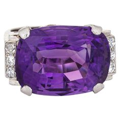 Stylish vintage amethyst & diamond cocktail ring crafted in 14 karat white gold. Oval faceted amethyst measures 18mm x 13.5mm. Six diamonds total an estimated 0.12 carats (estimated at H-I color and SI1-I1 clarity). The amethyst is in very good condition and free of cracks or chips. The east to west setting highlights the beautiful rich royal purple amethyst making this ring a standout! The medium rise ring (10mm - 0.39 inches) sits comfortably on the finger. The ring is in very good condition a Amethyst Cocktail Ring, Vintage Cocktail Ring, American Government, Amethyst And Diamond Ring, Diamond Cocktail Ring, Cocktail Jewelry, Gold Cocktail Ring, Gold Cocktail, Diamond Cocktail Rings