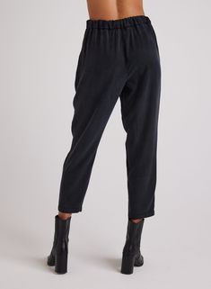 The Nico Clean Waist Slouchy Trouser is the perfect blend of style and comfort. With its clean waist and slouchy fit, this trouser is both fashionable and comfortable to wear. Expertly designed for a chic and relaxed look, these trousers are a must-have for any wardrobe. 100% TENCEL™ Lyocell. SIZE WAIST INSEAM FRONT RISE XS 27 1/2" 27 3/4" 12 1/2" S 29 1/2" 27 3/4" 13" M 31 1/2" 27 3/4" 13 1/2" L 33 1/2" 27 3/4" 14" Chic Pull-on Pants With Tapered Leg, Chic Viscose Bottoms With Tapered Leg, Chic Viscose Tapered Leg Bottoms, Viscose Ankle-length Pants For Work, Viscose Ankle-length Work Pants, Chic Pull-on Tapered Leg Pants, Chic Tapered Leg Pull-on Pants, Chic Tapered Leg Sweatpants For Loungewear, Chic Tapered Leg Viscose Pants