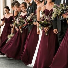 the bridesmaids are all dressed in maroon dresses