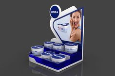 a display case with six jars of creams in front of an advertisement for nivea