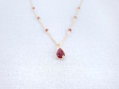 Garnet Pendant - Gold Garnet Necklace - Teardrop Necklace - Birthstone Necklace - Red Drop Necklace - January BirthstoneThe tiny red stone necklace is made of Garnet stone. Garnet is a stone of prosperity and abundance, encouraging gratitude and service to others.Garnet is the birthstone for the month of January and makes a lovely birthday gift.-------------MATERIALThe Garnet stone is in a teardrop 8x12mm setting and is made via hydrothermal process.---------------------------------------------- Red Gemstone Drop Necklace For Gift, Red Drop Necklace For Gift, Red Gemstone Pendant Crystal Necklaces, Red Gemstone Pendant Crystal Necklace, Red Pendant Crystal Necklaces With Gemstone, Red Teardrop Gemstone Drop Necklace, Red Crystal Pendant Necklaces, Red Teardrop Gemstone Necklace, Ruby Drop Necklace For Gift