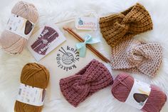 knitting supplies laid out on a white blanket