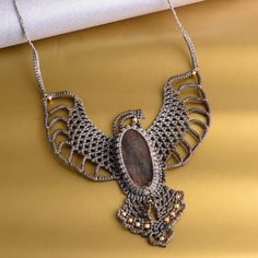 a necklace with an owl design on it