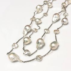 Big Baroque Pearl & Keshi Pearl Sterling Silver Rhodium Plated Chain Necklace 40" **Handmade : Each piece of pearl is wire-wrapped with sterling silver wire by hand. **Due to the organic nature of pearls, there is some minor difference in shape and color of each piece of pearl. Materials : Pearl : Top quality 11.5-14.5mm big size baroque pearl  13 pieces,            Top quality 9-10mm Keshi pearl 14 pieces Chain : Sterling silver rolo chain in rhodium plating Clasp : Sterling Silver lobster clas Silver Baroque Pearl Long Necklace, Silver Long Necklace With Pearl Chain As Gift, Silver Long Necklace With Pearl Chain For Gift, Silver Single Strand Pear-shaped Necklaces, Pearl Long Necklace, Wrapped Necklace, Wire Wrapped Necklace, White Freshwater Pearl, Keshi Pearls