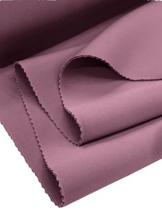 purple sheets folded on top of each other with scalloped edges in the middle