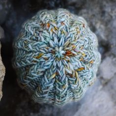 a rock with a blue and yellow ball on it