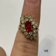 Vintage "Dinner Ring" with red gem in center surrounded by clear gems. Vintage ring inventory form my great grandmother's restaurant and gift shop in Silverton, CO that she owned and operated from the 1960s to 1996. Style V6 Sizes available: Size 6 - qty 1 Cluster Ruby Ring With Diamonds, Classic Red Cluster Diamond Ring, Classic Red Cluster Ruby Ring, Classic Red Ruby Cluster Ring, Antique Red Diamond Ring With Rose Cut Diamonds, Red Victorian Diamond Ring, Vintage Ruby Cluster Ring With Center Stone, Red Ruby Cluster Ring With Center Stone, Red Cluster Diamond Rings