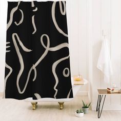 a bathroom with a black and white shower curtain