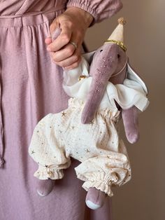 a person holding a stuffed animal in their hand