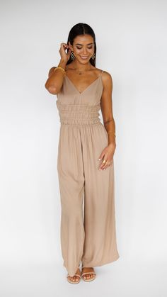 Stand out in this stunning Khush Clothing jumpsuit, made to flow with buttery soft rayon and an exaggerated wide pant leg. Features adjustable straps and a gentle smocked waist to flatter. ** Our Model is 5'8" and wearing a size SMALL. ** Fabric and Care Instructions: *100% Rayon *Hand wash cold *Line Dry Summer Beige Jumpsuits And Rompers With Elastic Waistband, Chic Rayon Jumpsuits And Rompers For Spring, Sleeveless Jumpsuits And Rompers With Smocked Back For Brunch, Sleeveless Rayon Jumpsuits And Rompers For Spring, Chic Smocked Bodice Jumpsuits And Rompers For Brunch, Chic Flowy Jumpsuits And Rompers For Brunch, Chic Flowy Jumpsuits For Brunch, Chic Maxi Length Jumpsuits And Rompers With Elastic Waistband, Elegant Beige Jumpsuits And Rompers For Loungewear