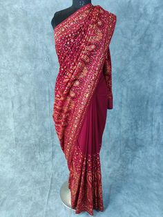 Kashmiri Embroidered Saree on Georgette with thread embroidery and some stones Fabric:  Georgette Length: 5.5 Meters | 6.1 yards Colour: Wine Blouse: Saree comes with blouse fabric. Base Color is same as Saree with border for sleeves or however you desire Please see product video for product details. If you have any questions message us anytime. Fall and Edging will be done complimentary.  Blouse Stitching (If Requested): Blouse will be stitched according to your measurements, which we will ask Thread Work Saree Embroidery, Traditional Pre-draped Saree With Dori Work For Eid, Embroidered Dola Silk Choli For Traditional Ceremonies, Embroidered Semi-stitched Choli With Traditional Drape, Bollywood Style Embroidered Pre-draped Saree For Diwali, Art Silk Pre-draped Saree With Intricate Embroidery, Embroidered Silk Pre-draped Saree In Traditional Drape, Jamawar Choli With Resham Embroidery For Reception, Unstitched Jamawar Choli With Intricate Embroidery