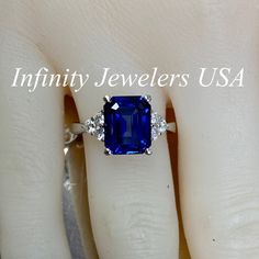 "This ring is an emerald cut lab created blue sapphire with round moissanite sides, 14k white gold # 6312 We feature the finest quality of lab grown sapphires in the world. The properties of lab-grown are physically, chemically and visually identical to natural, just grown in a lab setting. -Approximate total carat weight: 3.85ctw. diamond equivalent -Center Stone Size: approx. 3.55ct. diamond equivalent -Center Stone Shape: emerald cut 10x8mm -Gem Type: lab created blue sapphire -Stone Clarity: Gia Certified Radiant Cut Sapphire Diamond Ring, Blue Baguette Cut Emerald Ring, Blue Gia Certified Emerald Ring For Formal Occasions, Blue Radiant Cut Lab-created Sapphire Ring, Blue Diamond Asscher Cut Emerald Ring, Gia Certified Emerald Cut Sapphire Rings, Gia Certified Sapphire Emerald Cut Ring, Blue Emerald-cut Sapphire Diamond Ring, Blue Emerald-cut Moissanite Jewelry