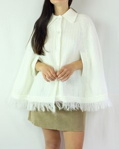 This is such a special piece! This 70s knit poncho cape is so perfect for everyday wear, and can be paired with so many looks and styles. The collar on this piece is lovely, the fringe is fun, and the material (acrylic) is soft and warm. This cape has slits in the front for you to use your arms. This is a button up piece as well, and is in excellent condition for it's age, and for being white! There are no flaws to note. ☼ Brand - Flair Fashions ☼ Material - 100% Acrylic ☼ Color - White ☼ Size - Chic White Winter Cape, White Shawl Poncho For Spring, Oversized White Cape Outerwear, White Oversized Winter Cape, White Long Sleeve Cape For Spring, White Long Sleeve Spring Cape, Chic White Cape For Fall, White Winter Poncho Cape, One Size Cream Cape