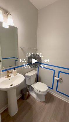 a bathroom with blue tape on the walls and white fixtures, along with a toilet and sink