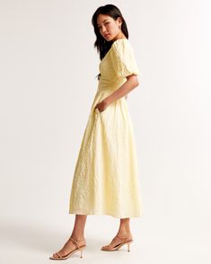 Step into the sunshine with the Abercrombie & Fitch Women's Tie-Front Textured Maxi Dress in a delightful pastel yellow. This dress combines elegance with comfort, making it a must-have for your wardrobe.

- **Size**: XS Petite
- **Color**: Pastel Yellow
- **Material**: Lining - Polyester, Elastane
- **Gender**: Female
- **Age Group**: Adult

This maxi dress features a flowy short-sleeve design crafted from soft textured seersucker fabric. The on-trend puff sleeves and plunging V-neckline add a Summer Maxi Length Puff Sleeve Dress For Daywear, Spring Maxi Length Puff Sleeve Dress For Day Out, Spring Puff Sleeve Maxi Dress For Day Out, Spring Midi Puff Sleeve Dress For Daywear, Chic Puff Sleeve Maxi Dress For Summer, Spring Day Out Puff Sleeve Short Dress, Spring Short Sleeve Puff Sleeve Dress For Day Out, Spring Puff Sleeve Short Sleeve Dress For Day Out, Spring Puff Sleeve Dress For Day Out