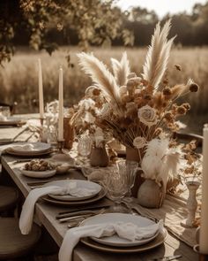 an outdoor table set with plates and place settings