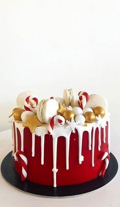 a red cake with white icing and candy canes